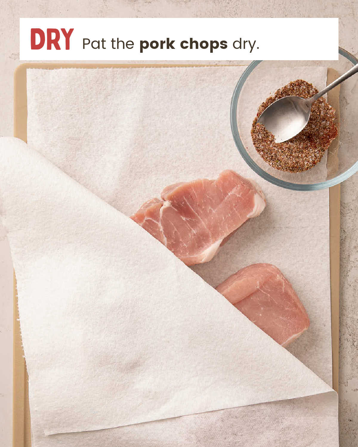 Raw boneless pork chops patted dry with paper towels.