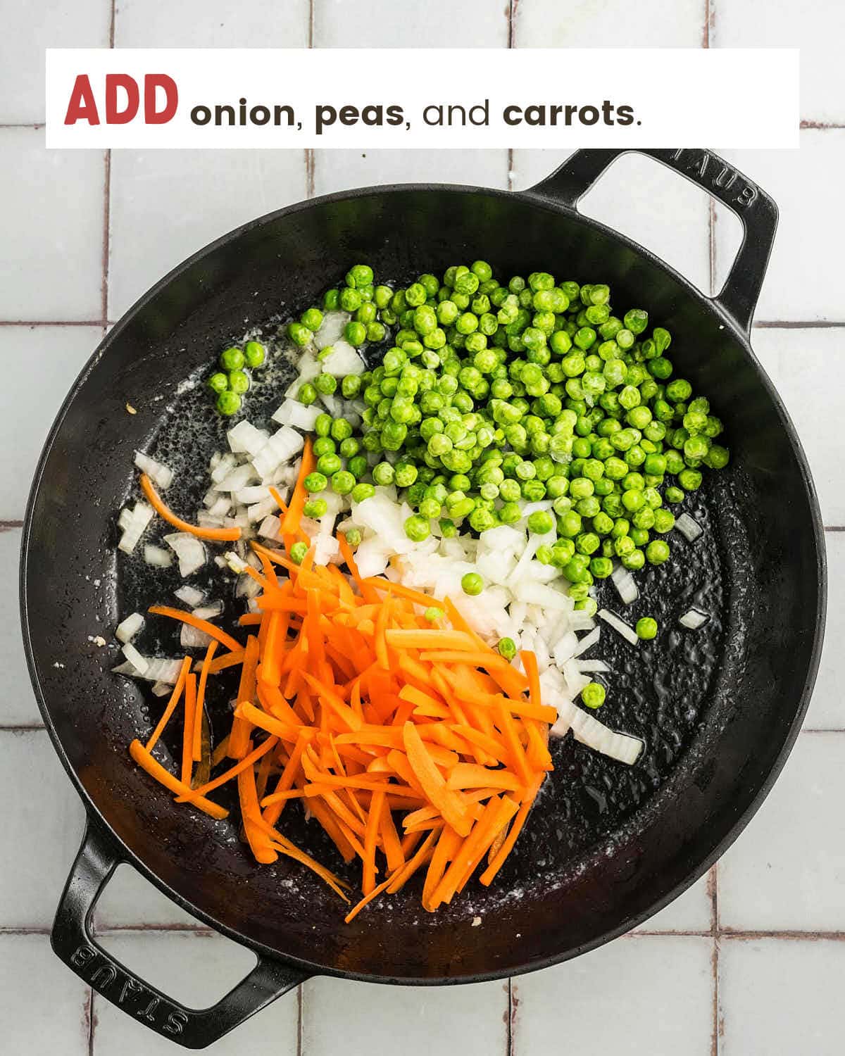 Onion, frozen peas, and julienned carrots added to the skillet.