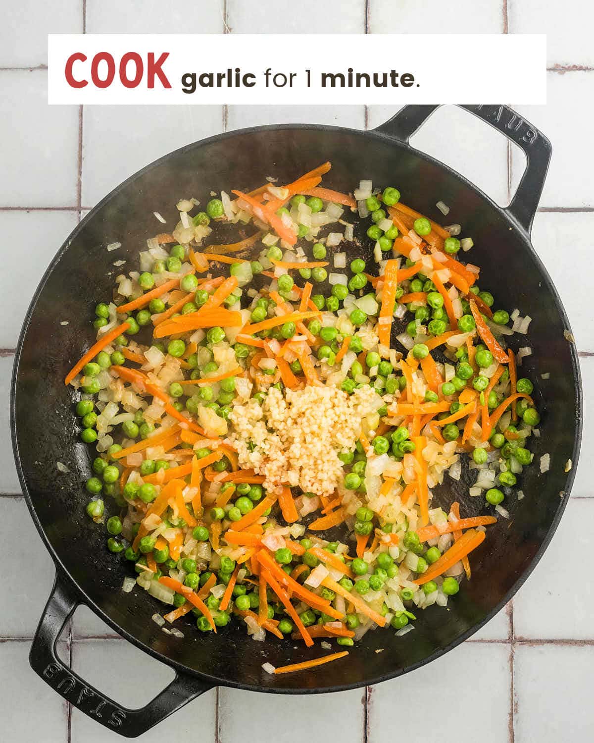 Minced garlic added to the softened vegetables.