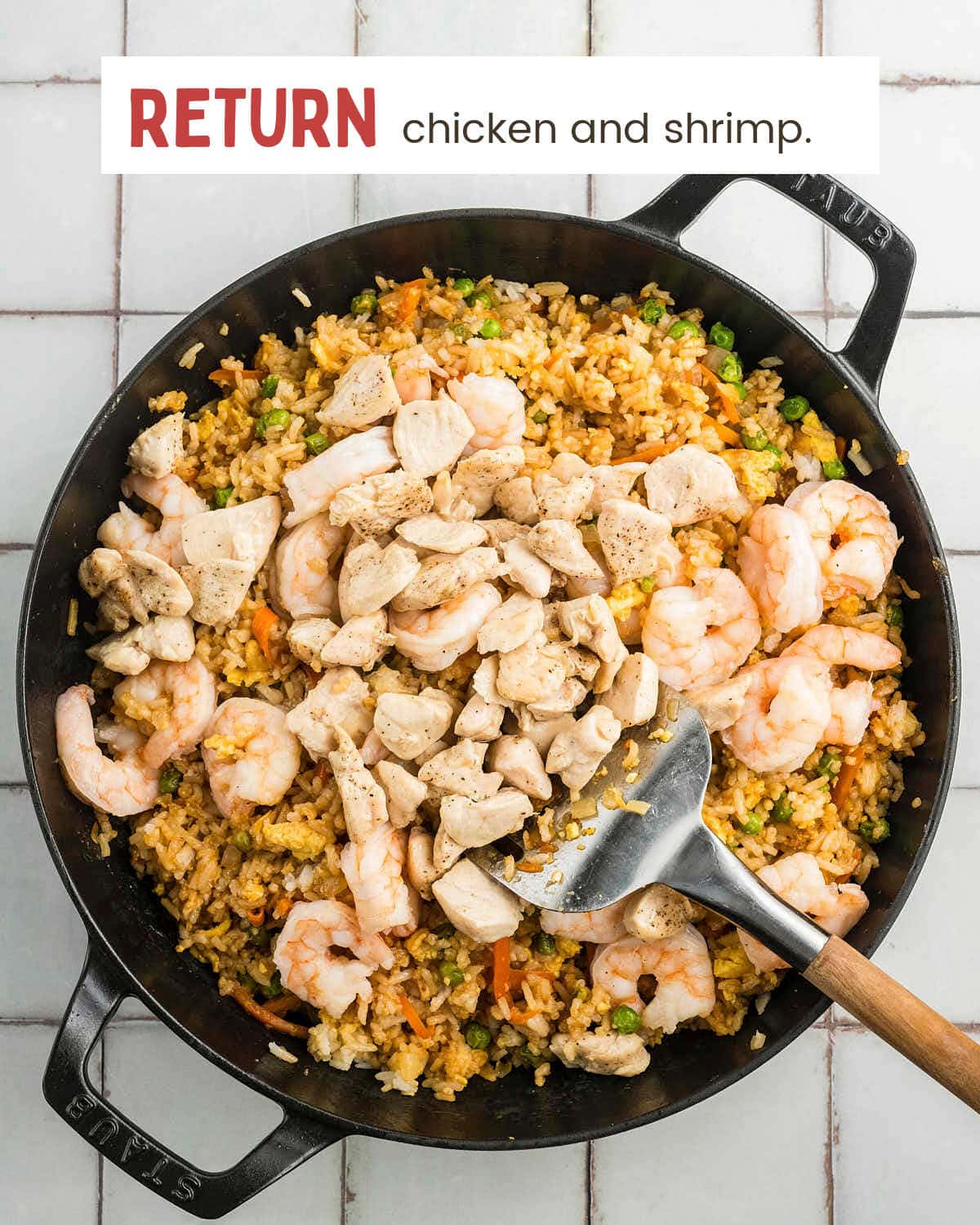 Cooked chicken and shrimp returned to the skillet of fried rice.