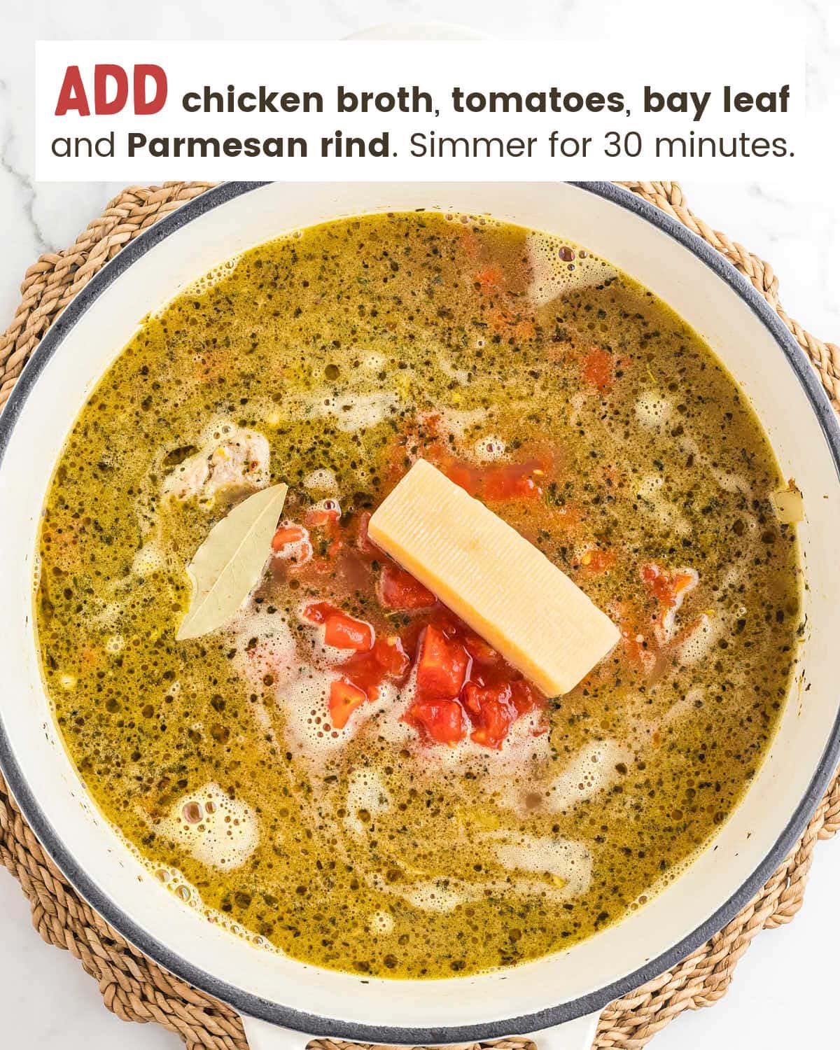 Broth with diced tomatoes, a bay leaf and a Parmesan rind added to the pot.