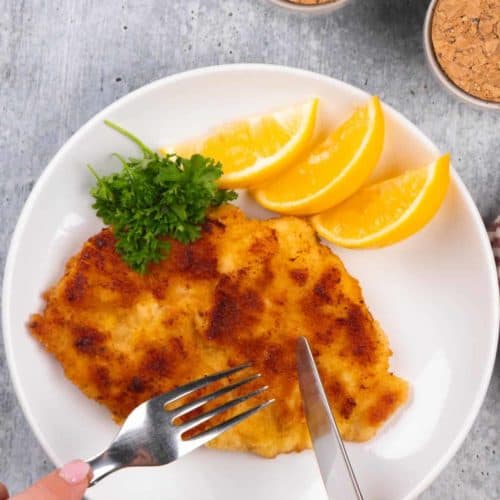 Cutting into the chicken schnitzel.