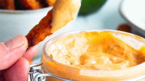 Dipping a sweet potato into Chipotle Mayo