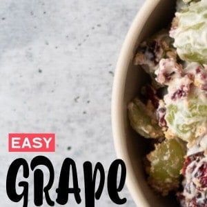 A bowl full of Grape Salad with cranberries and Graham Crackers