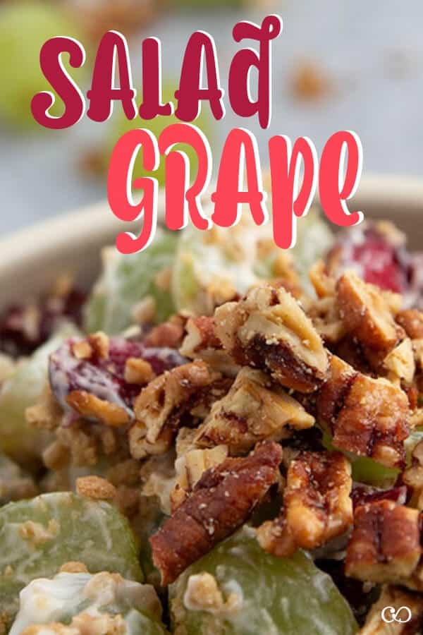 A bowl full of Grape Salad with cranberries and Graham Crackers