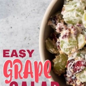 A bowl full of Grape Salad with cranberries and Graham Crackers