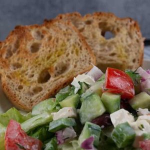 Salad bowl with Greek Salad and two slices of toasted gluten free bread
