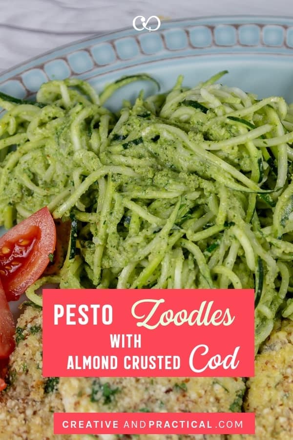 Zoodles (spiralized zucchini noodles) in homemade pesto are served with almond-crusted cod. This dish is a delicious, easy, and all gluten-free dinner option. Perfect for a quick midweek dinner. #cheerfulcook #glutenfree #zoodles #noflour #baked #cod #recipe #easy | cheerfulcook.com via @cheerfulcook
