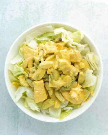 A bowl of curry chicken salad with grapes