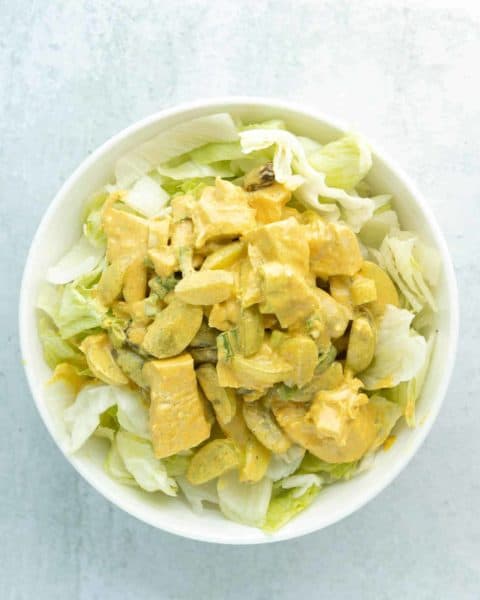 A bowl of curry chicken salad with grapes