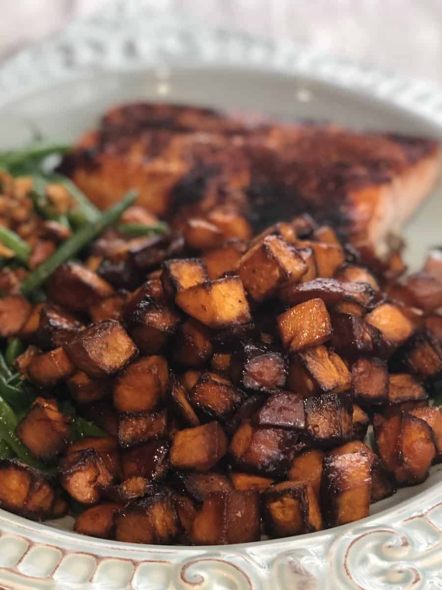 Honey Roasted Sweet Potatoes on a serving platter with a few green beans. 