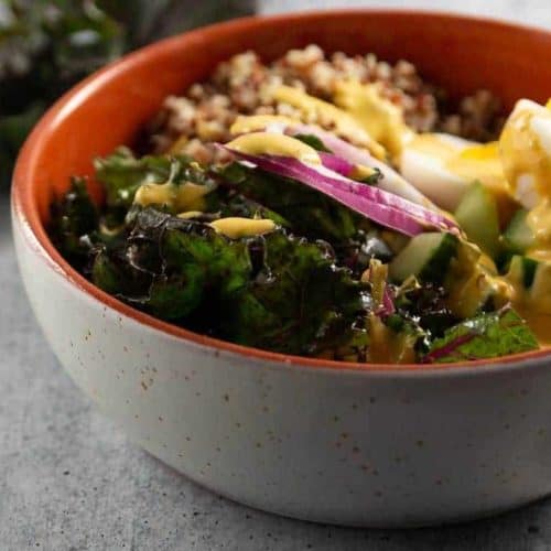 Kale and Quinoa Salad Bowl. Made with a hard boiled egg, cucumber, and red onion.