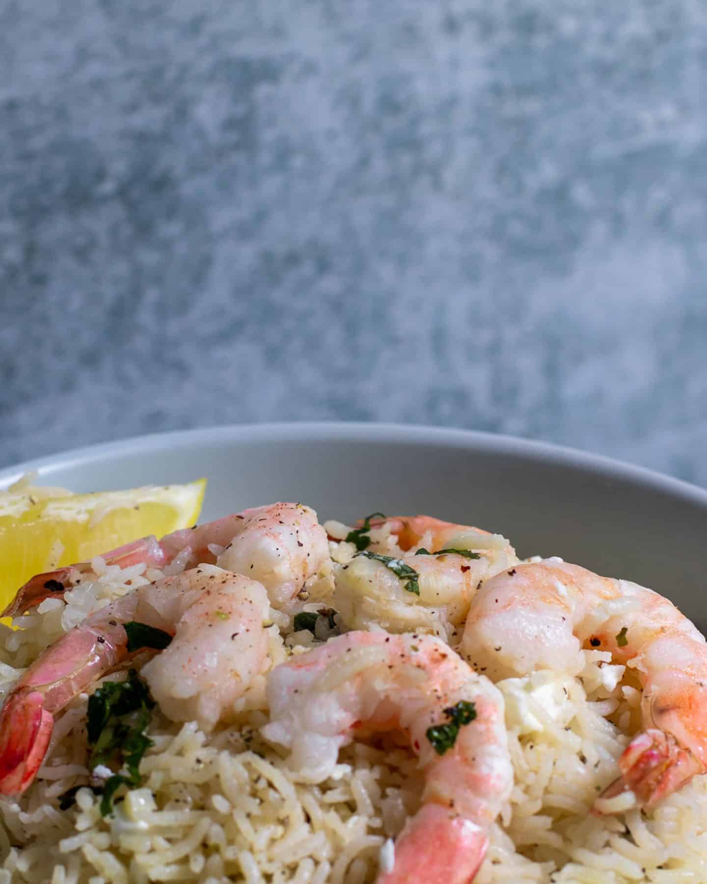 Mint Rice with shrimp and a wedge of lemon.