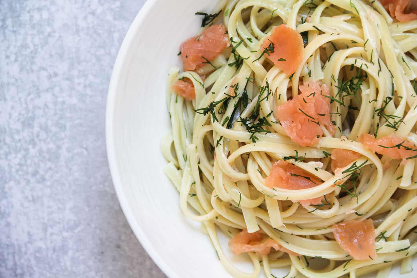 Freshly cooked Smoked Salmon Pasta served in a white pasta bowl.