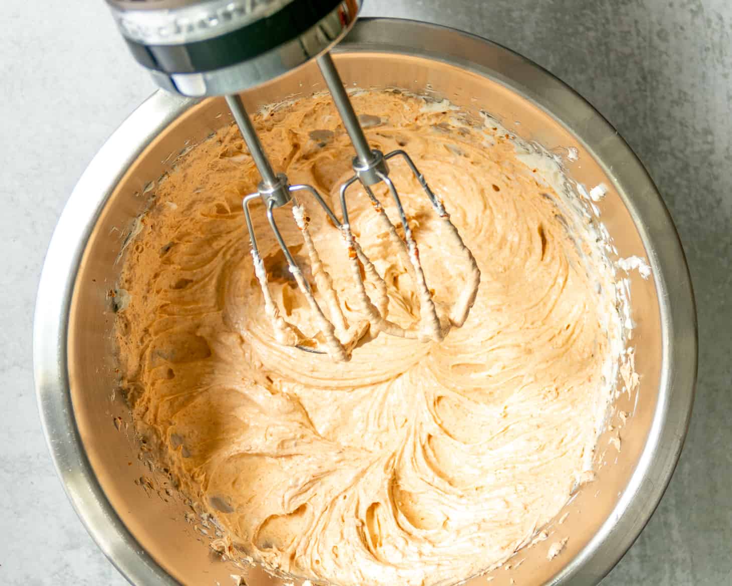 Use an electric hand mixer to combine cream cheese, sour cream, and taco mix.