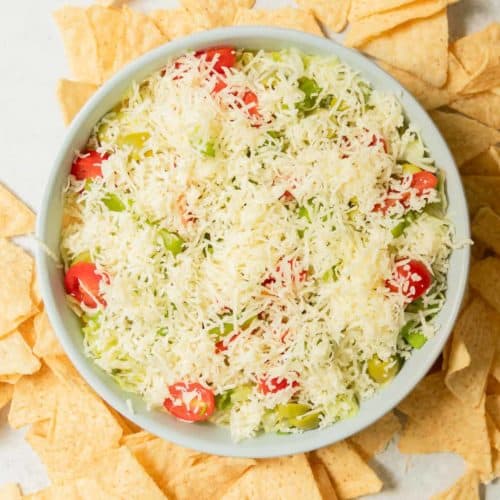 A bowl of taco dip with chips